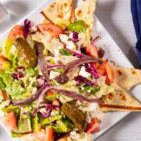 Greek Salad · Crisp lettuce, tomatoes, cucumbers, feta cheese, onions, olives, stuffed grape leaves and an...