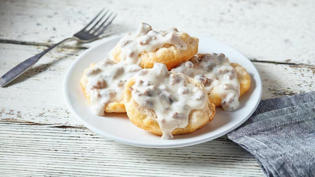 2 Biscuits & Gravy · Two fluffy, open-faced biscuits topped with country sausage gravy.