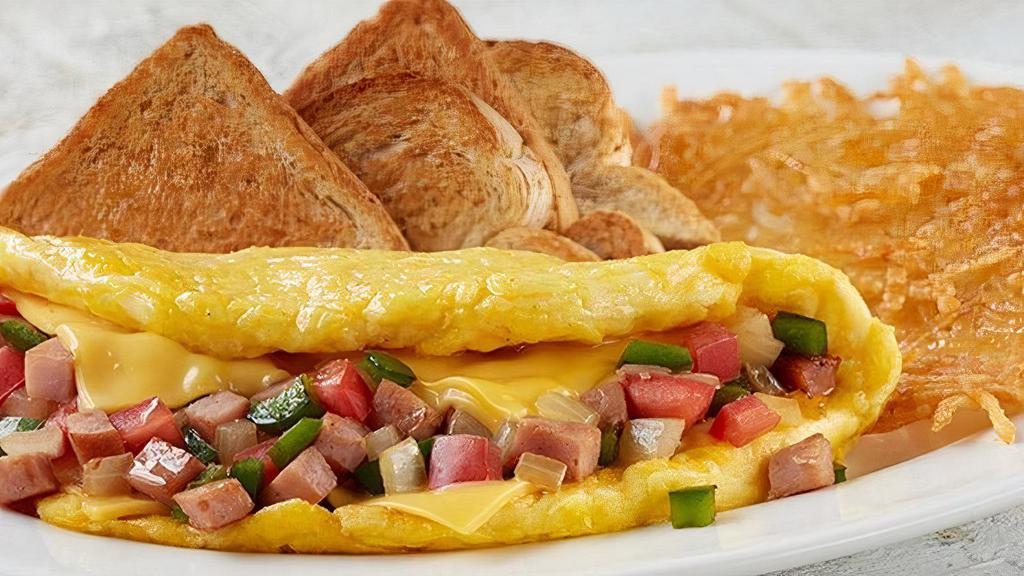 Omelet-Western · Diced sugar cured ham, American cheese, green bell peppers, onions and tomatoes served with your choice of homestyle grits or crispy hashbrowns or seasonal fruit, and buttery toast or biscuit (Cal 725-930)
