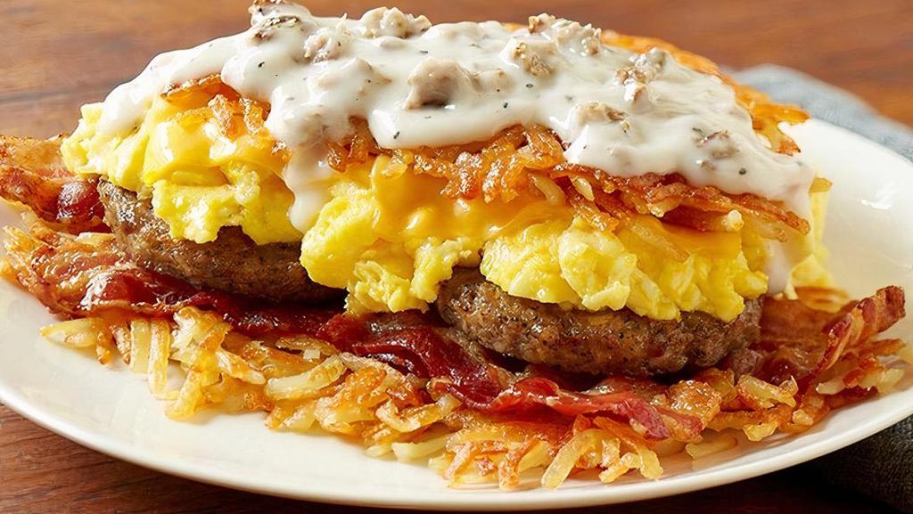 Bacon, Sausage & Sausage Gravy · Sizzlin’ Applewood smoked bacon, country sausage, two scrambled eggs* and melty American cheese stuffed between layers of crispy hashbrowns smothered with country sausage gravy, served with buttery toast or biscuit.
