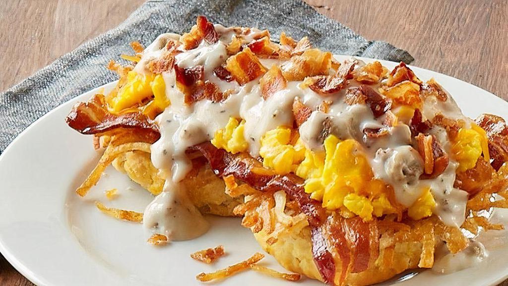 Southern Smothered Biscuit Platter W/ Bacon · An open-faced biscuit, crispy hashbrowns, gravy, cheddar cheese and 2 scrambled eggs* topped with sizzlin’ chopped bacon and country sausage gravy  (Cal 1020)