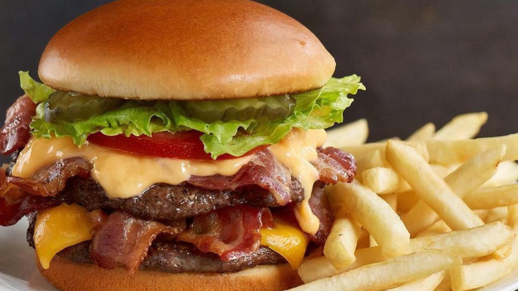 Mega Bacon Cheese Huddleburger® · Two-patty burger stacked with four strips of Applewood smoked bacon, melted cheddar cheese, fresh lettuce, tomato slices and pickle chips then smothered with cheddar cheese sauce on a toasted brioche bun (Cal 1075-1550)