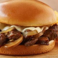 Roasted Prime Rib Tips · Tender prime rib tips piled on a toasted brioche bun, topped with Swiss cheese, sautéed mush...