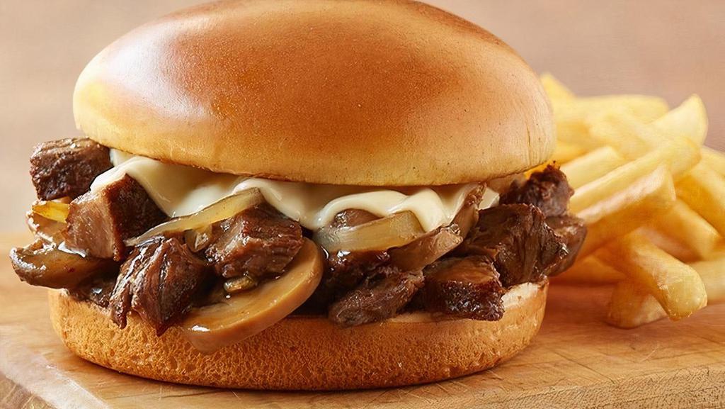 Roasted Prime Rib Tips · Tender prime rib tips piled on a toasted brioche bun, topped with Swiss cheese, sautéed mushrooms and caramelized onions, served with au jus (Cal 645-1120)