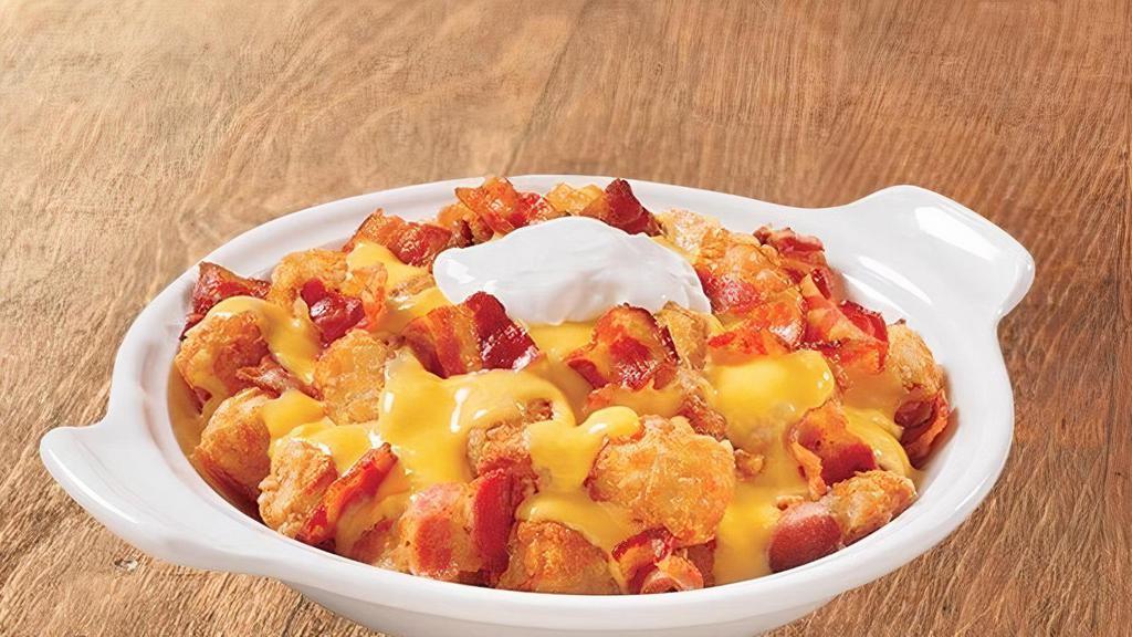Cheesy Bacon Tots · Crispy tater tots topped with sizzlin' chopped bacon and warm cheddar cheese sauce (Cal 1210)