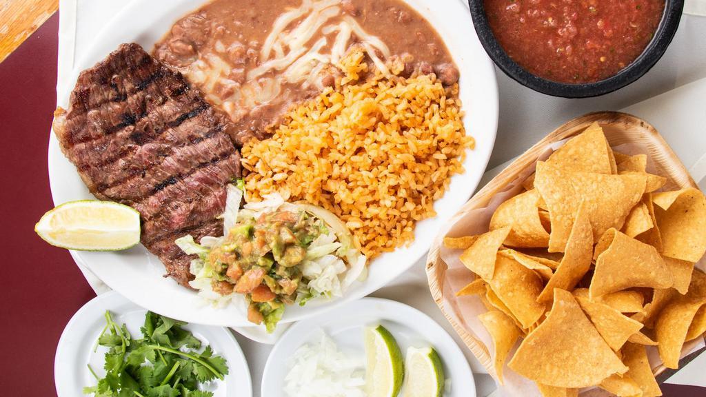 Carne Asada ￼ · Grilled steak served with rice and beans 2 corn or 1 flour tortilla