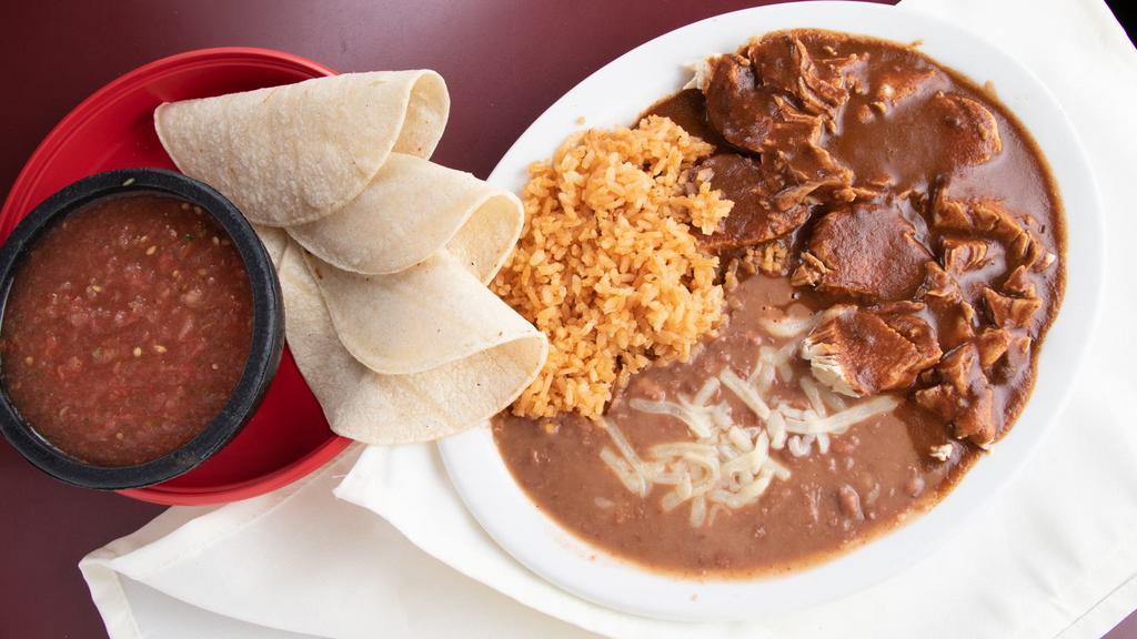 Pollo Con Mole ￼ · An ancient aztec sauce, made with chiles, nuts, and chocolate.