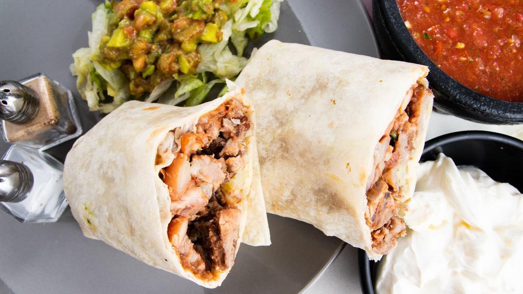 Steak Burrito · Served with rice and beans.