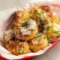Garlic Knots · Five garlic knots tossed in garlic, olive oil, butter and Parmesan cheese served with marina...