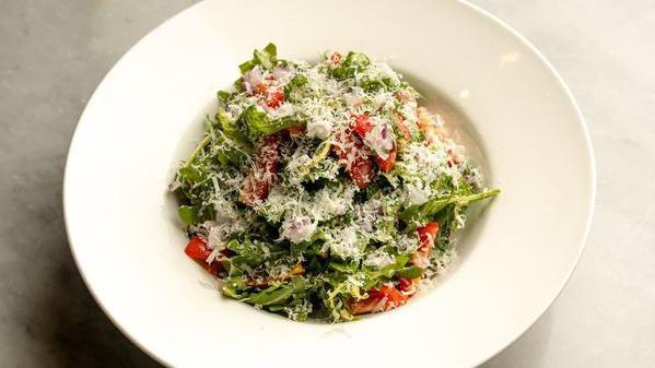 Arugula Salad · Arugula, cherry tomatoes, onion, fresh parmesan cheese served with balsamic dressing on side.