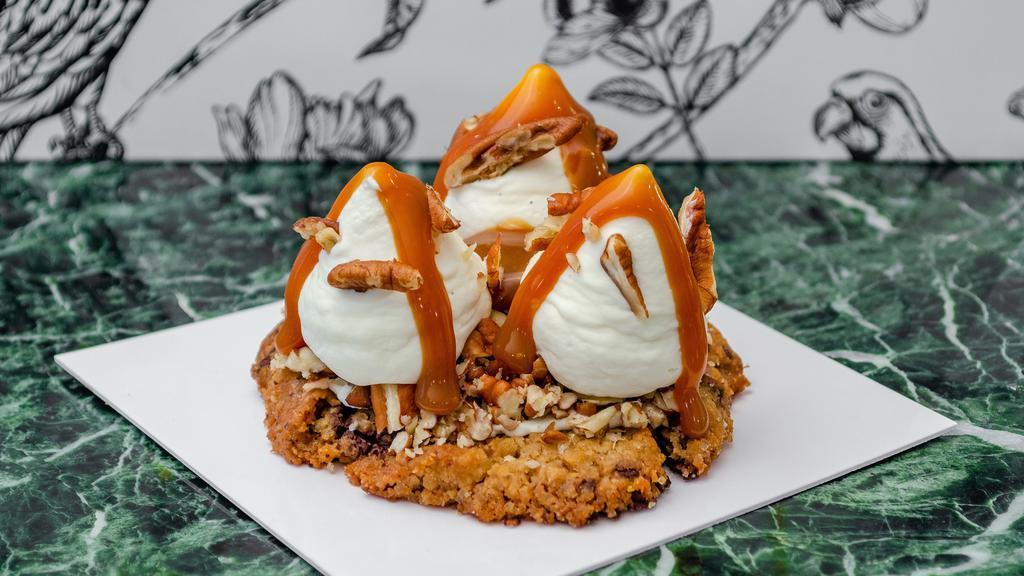 Caramel Dulce De Leche Cookie · Salted chocolate chip cookie topped with dulce de leche chantilly, a toasted mix of nuts, salted caramel sauce, and orange zest