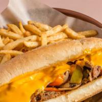 Philly Cheesesteak · Shaved ribeye steak with peppers, onions and cheddar cheese sauce.