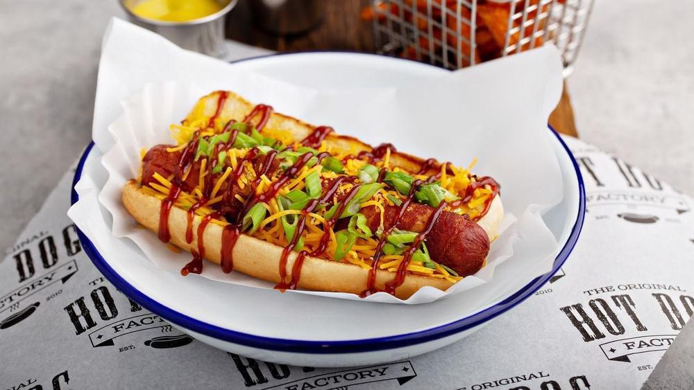 Memphis Dog · Deep fried bacon wrapped 100% certified angus beef hot dog topped with shredded cheese, BBQ sauce, and green onion.  Protein and toppings can be modified.