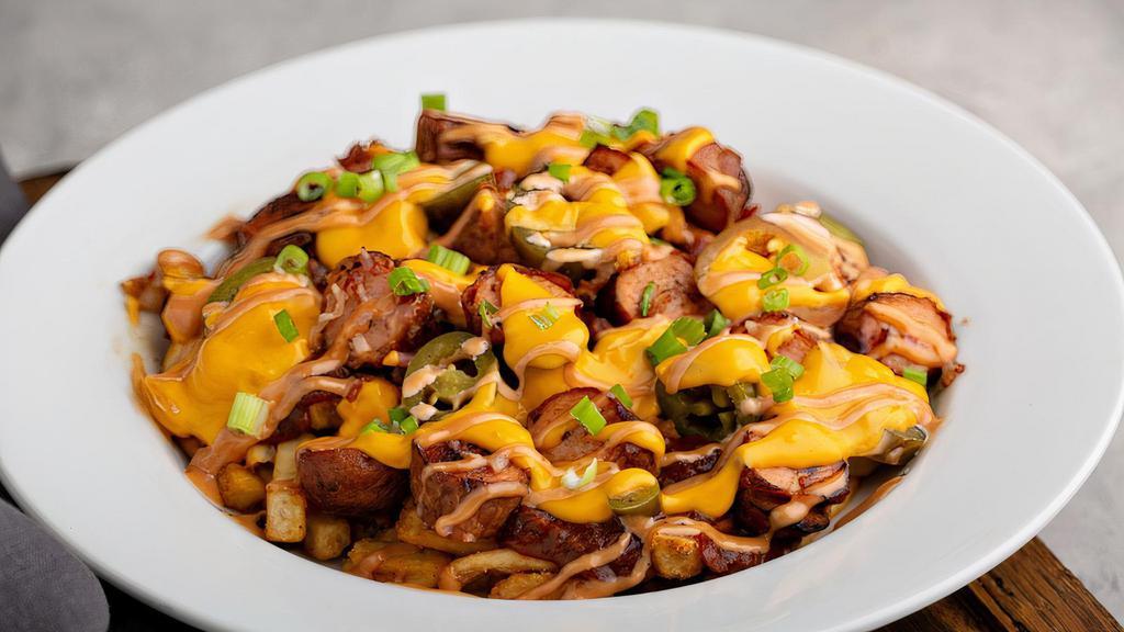 Factory Loaded Fries · Large chili cheese fries with shredded bacon, diced hot dogs, jalapeños, green onions, and try me sauce.