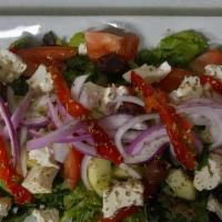 Greek Salad · Romaine Hearts, Cherry Tomatoes, Feta, Cucumber, Grape Leaves, Kalamata Olives, and Oregano
