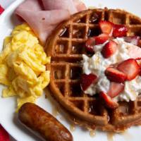 Waffle Deluxe · Served with 2 eggs, 2 strips of bacon, 2 slices of ham and 1 sausage link.