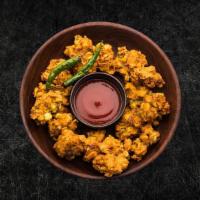 Golden Fried  Corn Frittersâ (Vegan) · Fritters made from Indian corn dipped in a batter of gram flour, served with various savory ...