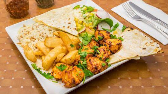 Chicken Shish Kebab · Fire roasted marinated cubes of chicken. Served with potato wedges, salad, white sauce, lavash bread and rice or bulgur (wheat).