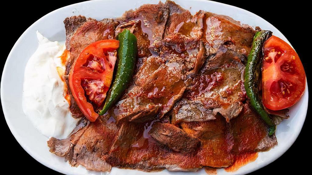 Iskender Kebab · Fried cut turkish bread, topped with gyro, tomato sauce, butter, and yogurt on the side.