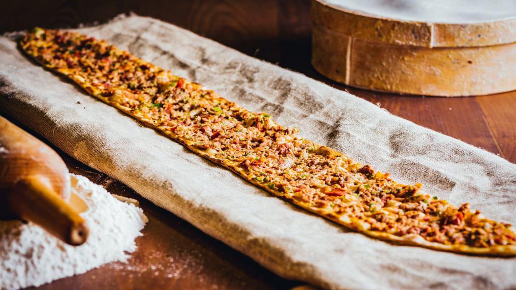 Kuşbaşı Pide · Thick dough crust topped w/ diced lamb & beef, tomatoes & peppers