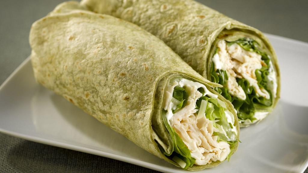 Vegan Chicken Caesar Wrap · Vegan chicken with vegan cheese, lettuce, tomato, and Caesar dressing, served on a spinach wrap.