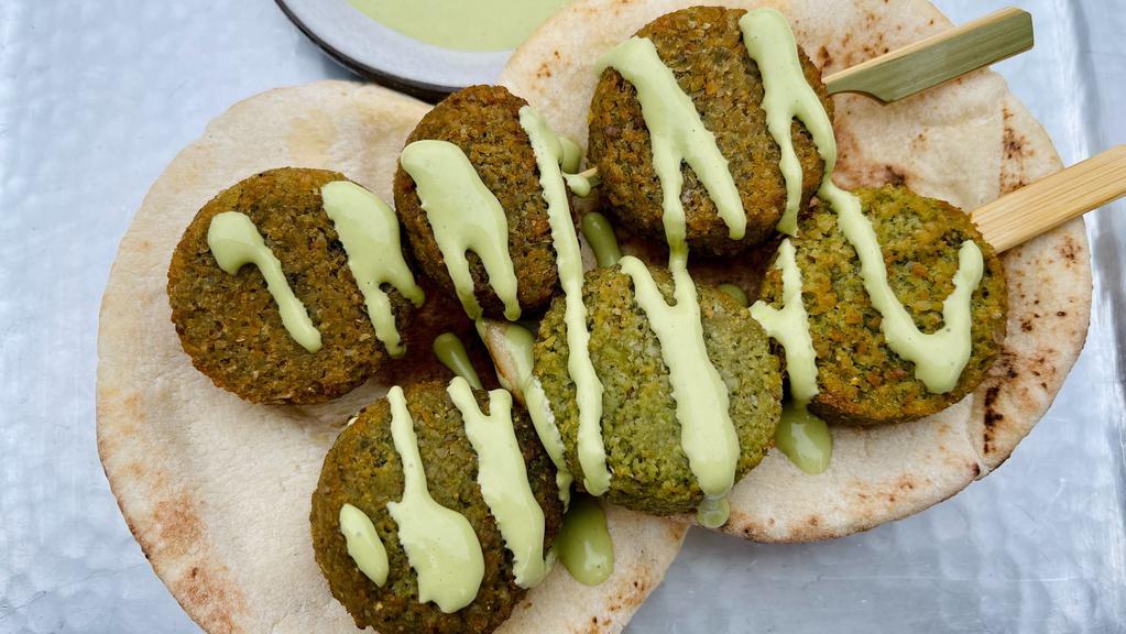 Falafel Skewer Party · Herby Baked Falafel Skewers served with a side of pita and cilantro lime tahini