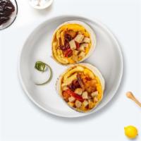 Sausage Breakfast Burrito · Sausage, tator tots, egg, and  cheddar cheese, tomatoes and caramelized onions wrapped in a ...