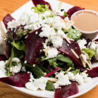 Roast Beet And Goats Cheese Salad · Roasted beet, goat cheese, and almonds, served over mixed greens.