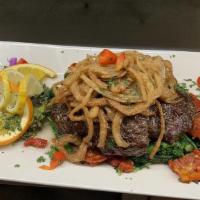 Broiled Roumanian Skirt Steak · With mushrooms and grilled onions.