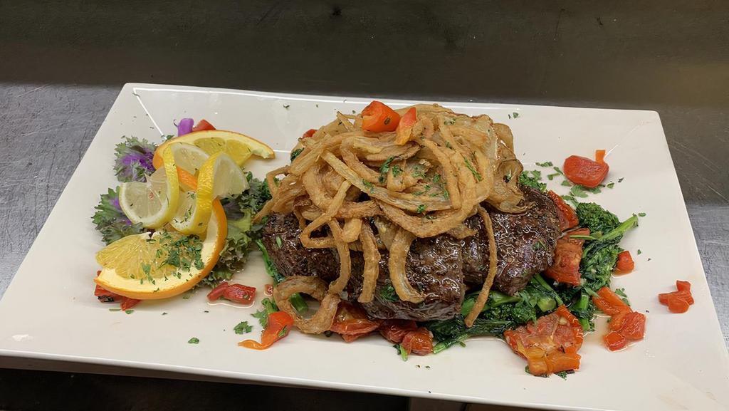 Broiled Roumanian Skirt Steak · With mushrooms and grilled onions.