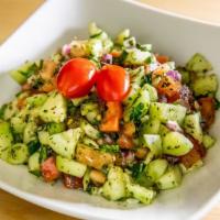 Yara Salad · Tomatoes, cucumber, red onion, parsley, mint, pomegranate molasses, lemon juice and olive oil.