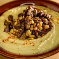 Beef Hummus · Chickpea puree, tahini, garlic, lemon juice, topped with sautéed beef and pine nuts.