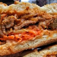 Coconut Curry Beef Sandwich · Coconut curry shredded flank steak topped with fried shallots.