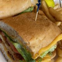 Buffalo Chicken Sandwich · Fried chicken, Swiss cheese, lettuce, tomato, red onion, and Buffalo sauce. Served with Fren...