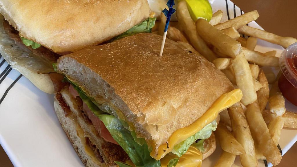 Buffalo Chicken Sandwich · Fried chicken, Swiss cheese, lettuce, tomato, red onion, and Buffalo sauce. Served with French fries, onion rings, coleslaw, and pickle.