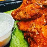 Buffalo Wings · Tossed in a mild or hot sauce, served with celery sticks and blue cheese.