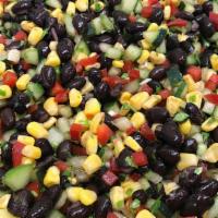 Black Bean Corn Salad · Black beans, refreshing cucumber, corn and red bell peppers tossed in Chanos' jalapeno vinai...
