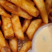 Crispy Fries · Chanos' own crispy seasoned fries with ketchup on the side. Shown with a side of small Queso...