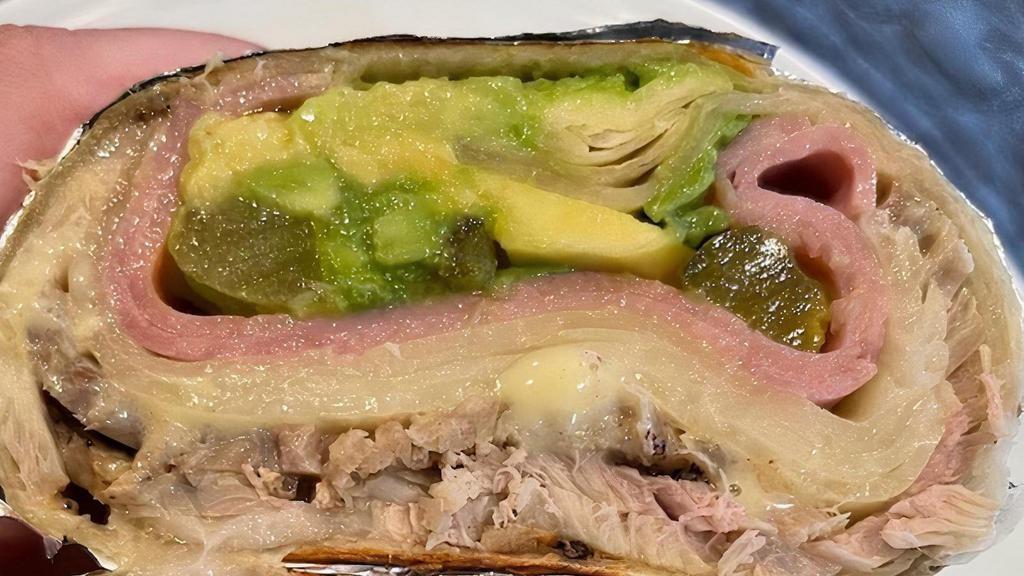 W Cubano · Thinly sliced roasted pork, sliced deli ham, provolone cheese, mustard, pickles & sliced avocado. Don't forget to add some of our delicious Crispy Fries on the side!
