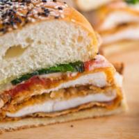 Chicken Parmigiana Panini · Grilled sandwich with breaded chicken, mozzarella cheese, tomato sauce, and fresh basil. Ser...