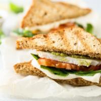 The Italiano Panini · Grilled sandwich with grilled chicken, roasted peppers, fresh mozzarella cheese, and pesto s...