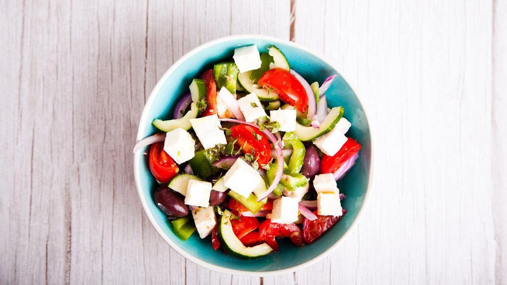 Greek Salad · Fresh salad with romaine lettuce, cherry tomatoes, cucumbers, peppers, red onions, feta cheese, and olives.