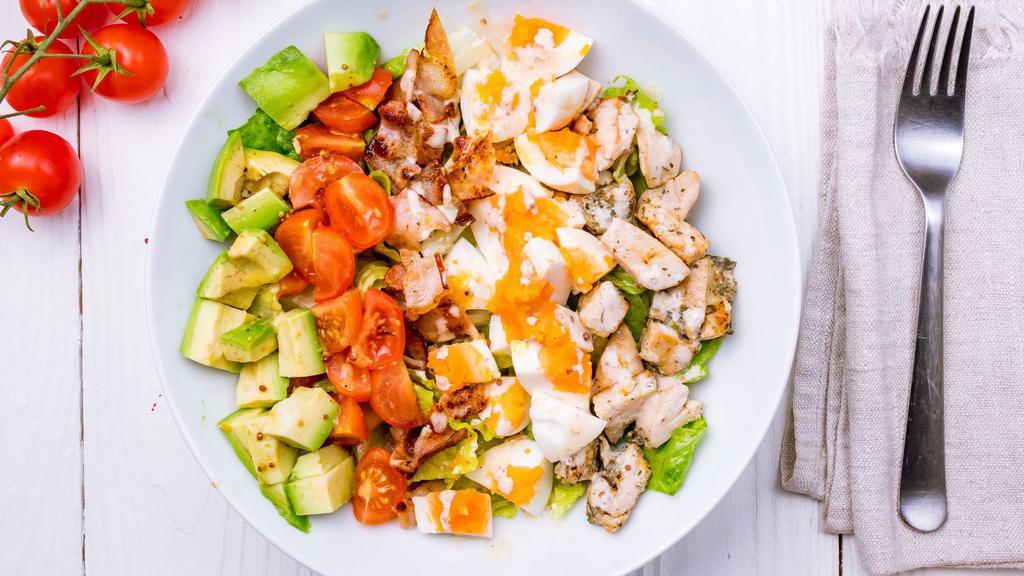 Cobb Salad · Fresh salad made with mixed greens, grilled chicken, carrots, mushrooms, tomatoes, and avocado.