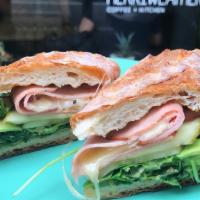 Tasty Ham & Cheese Sandwich · Rosemary Ham, White Cheddar, Pickles, Mustard and Arugula on a Toasted Baguette