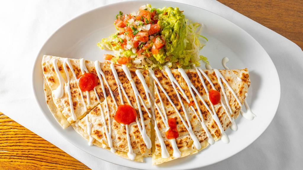 Quesadilla · Grande flour tortilla stuffed, with melted Chihuahua top with cheese, fresh crema and pico de gallo.