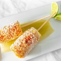 Elote · Two corn on cob. Spread with chipotle-mayo creamy sauce, sprinkled with cotija grounded chee...