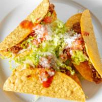 Tacos Gringos · Three crispy tacos. Three hard-shell corn tortilla, topped with shredded lettuce, ranchera m...