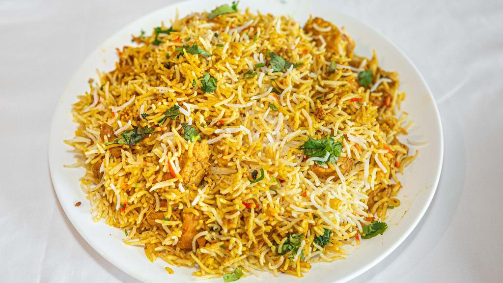 Chicken Biryani · Basmati rice cooked with chicken cardamom saffron and herbs.