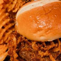 Cajun Burger* · Lightly Cajun burger topped with crispy fried onion straws and drizzled with buffalo sauce.