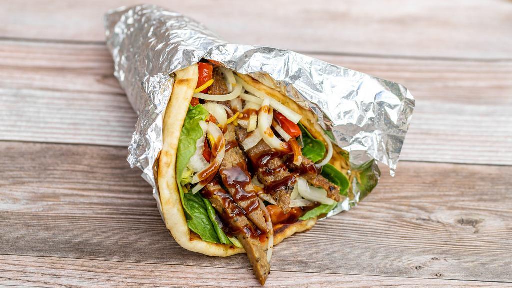 Lamb Gyro · Grilled Lamb Gyro served toasted Pita bread with house salad and your choice of white sauce, barbeque sauce and or hot sauce.